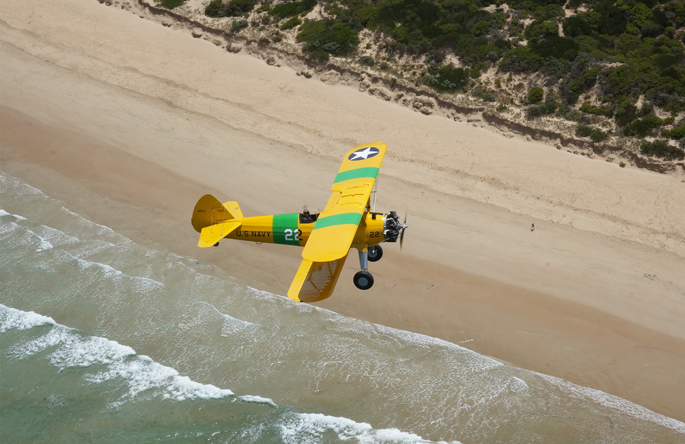 Biplane flying over Torquay's beautiful beaches
